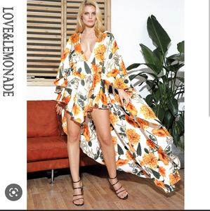 NWT love and lemonade size medium floral romper with draped cape back.